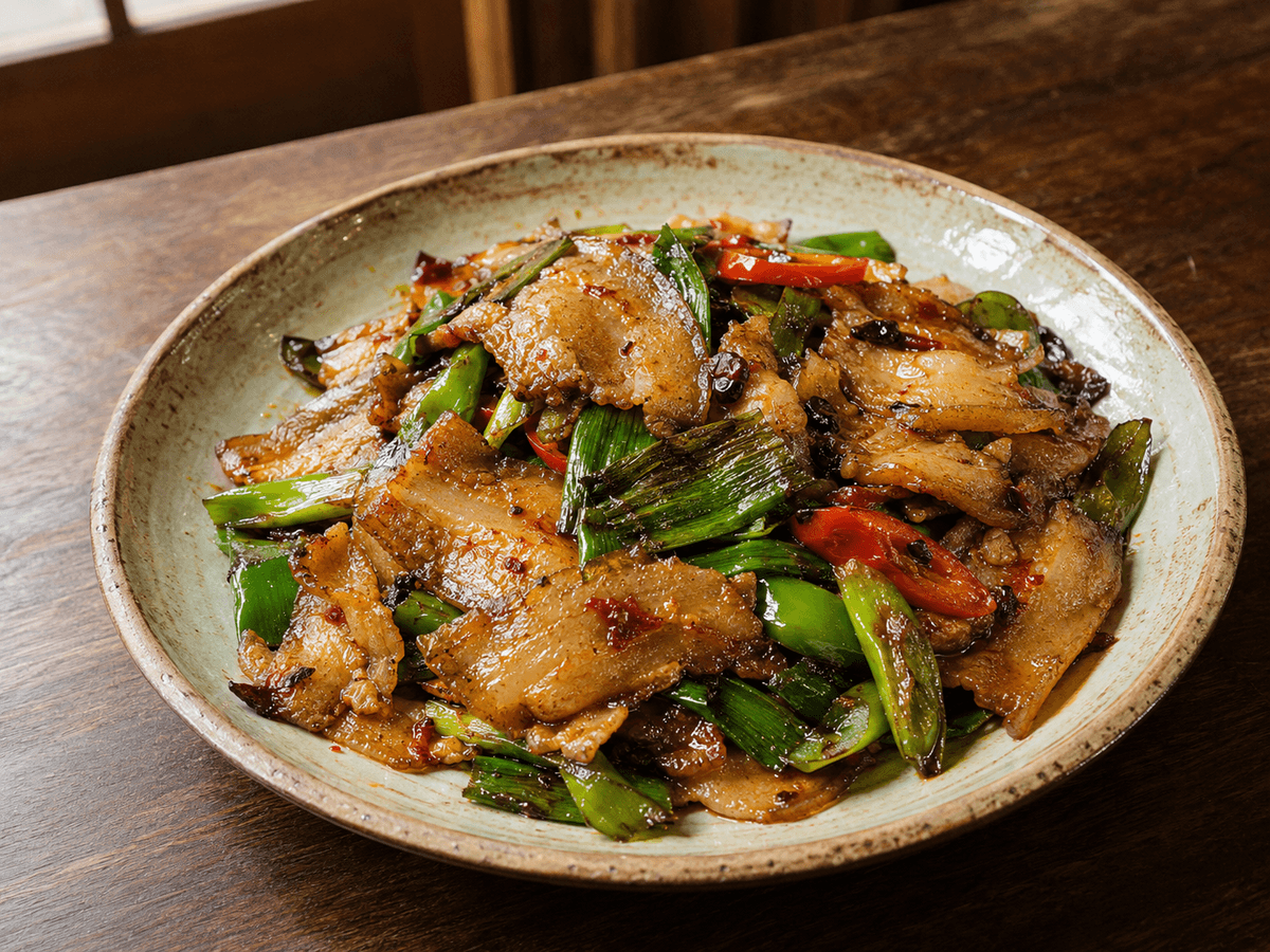Traditional Sichuan twice-cooked pork with green garlic, peppers and chili bean paste