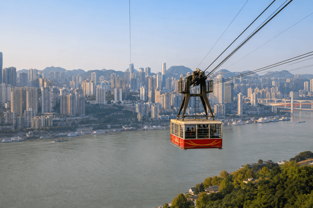 Yangtze River cable car crossing above the river with the Chongqing skyline behind it