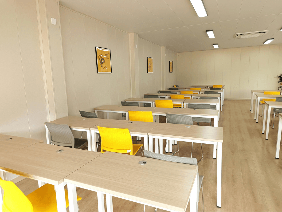 ouble-story modular school building using detachable container houses providing temporary classrooms for students in developing regions.