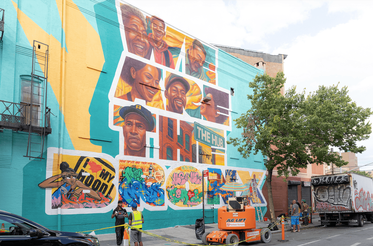 We Are The Bronx 2025 mural by Angurria featuring community portraits and colorful street art on a large city wall
