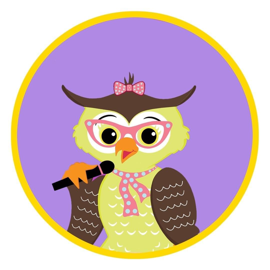 Luna Owl wearing glasses and singing in her microphone.