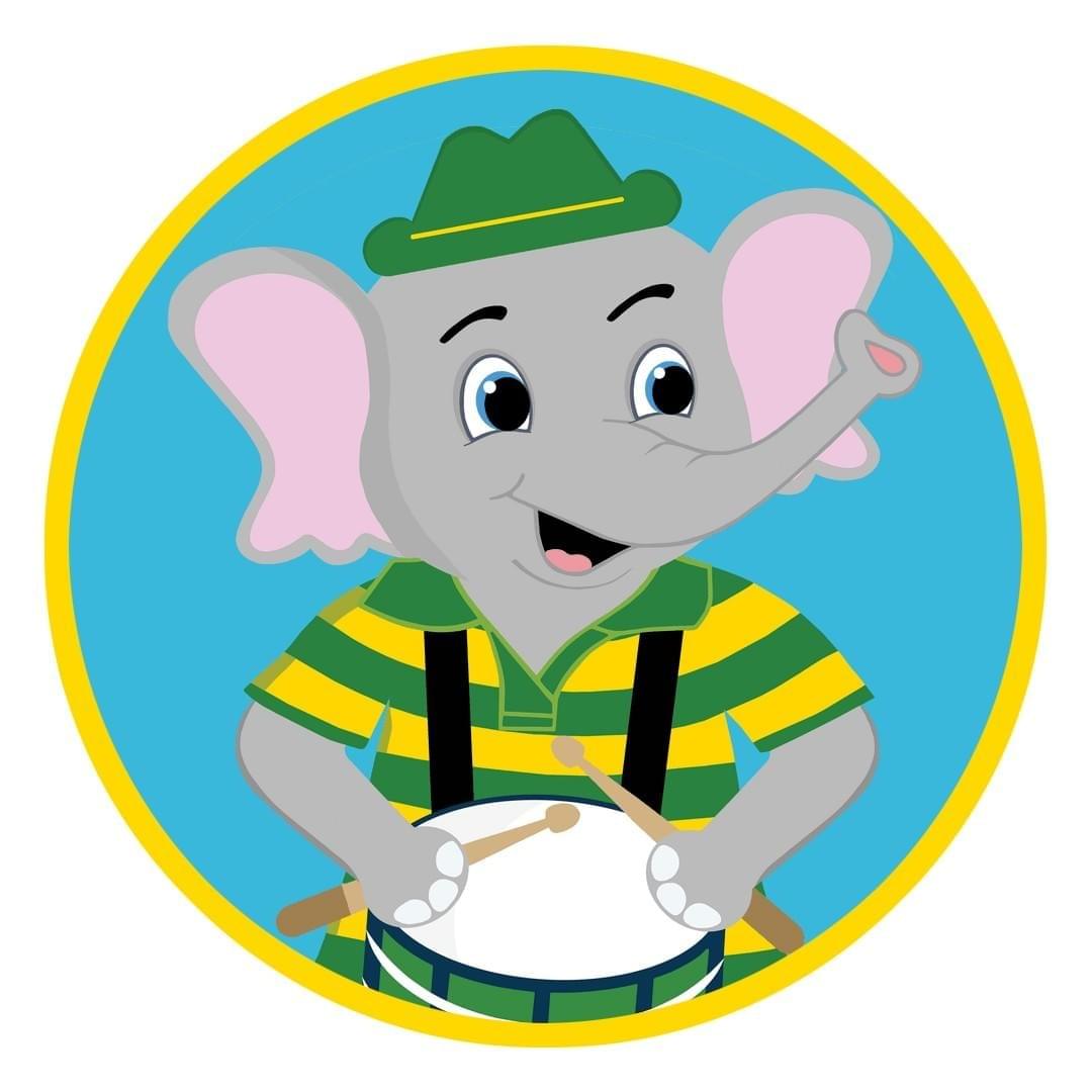 Ivan Elephant smiling and playing his drum. 