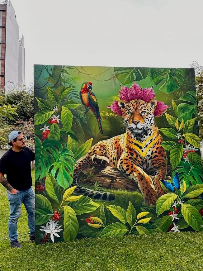Amazon rainforest mural by Zelva Uno featuring a jaguar surrounded by lush foliage with a parrot and butterfly symbolizing biodiversity and nature