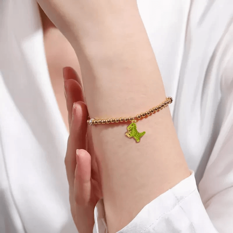 dinosaur charm bracelet showcasing colorful charms and gold accents
