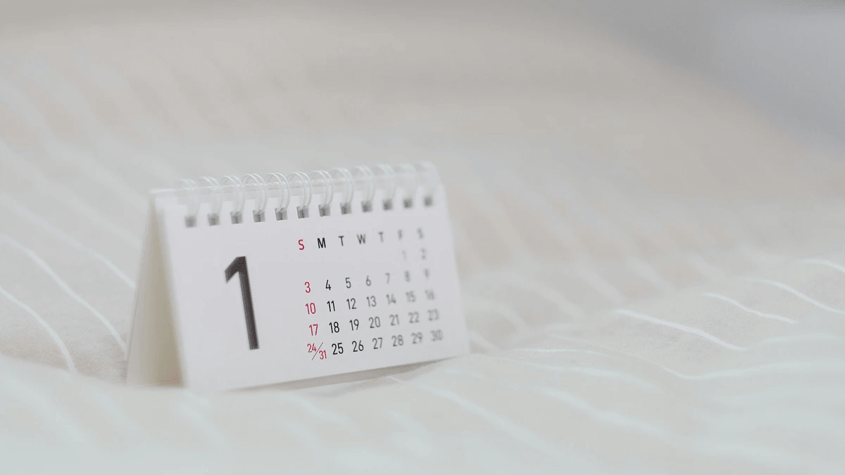  Open monthly planner on a wooden desk for organizing customer appointments