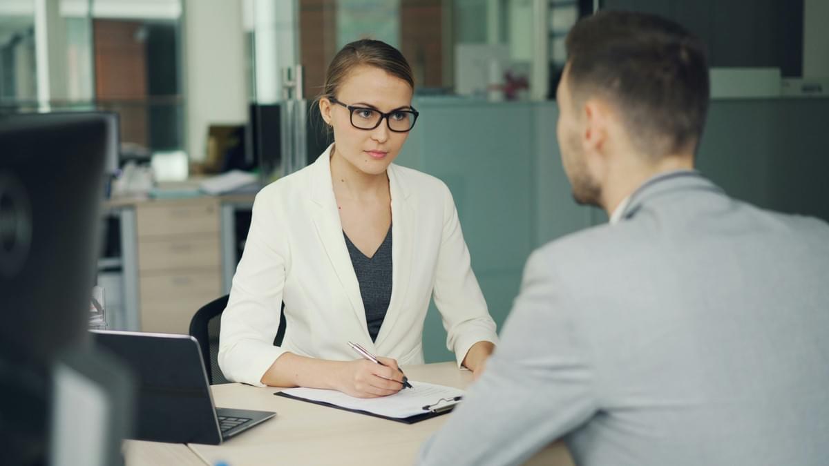 Consultant explaining a service plan to clients during a business meeting