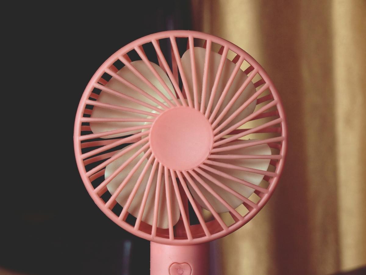 Mini portable fan inspection process showing grille security
