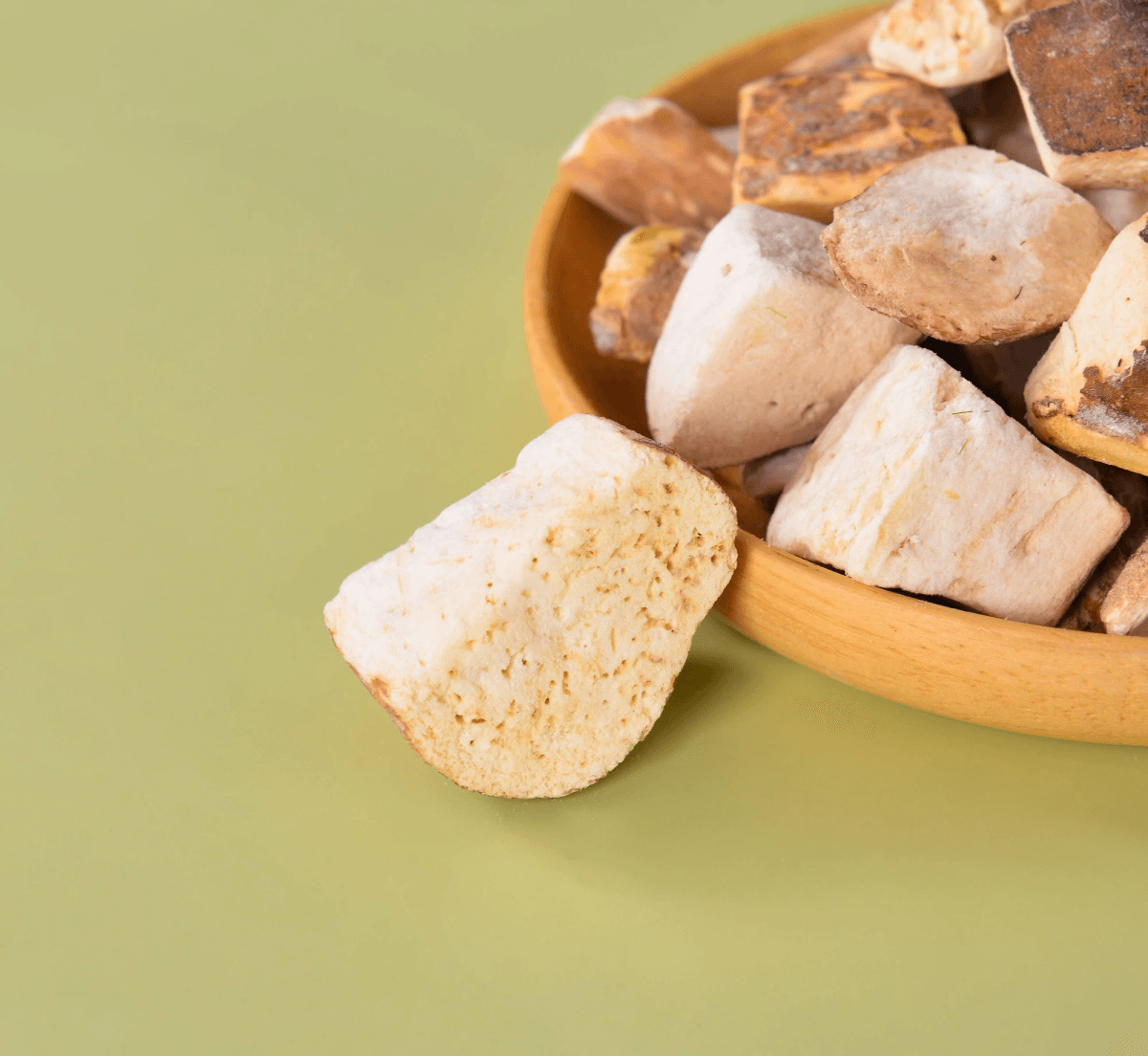 freeze dried porcini mushroom slices displayed on wooden board