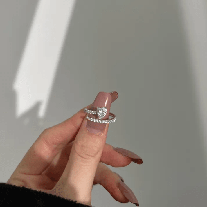 Intertwined hands wearing matching promise rings