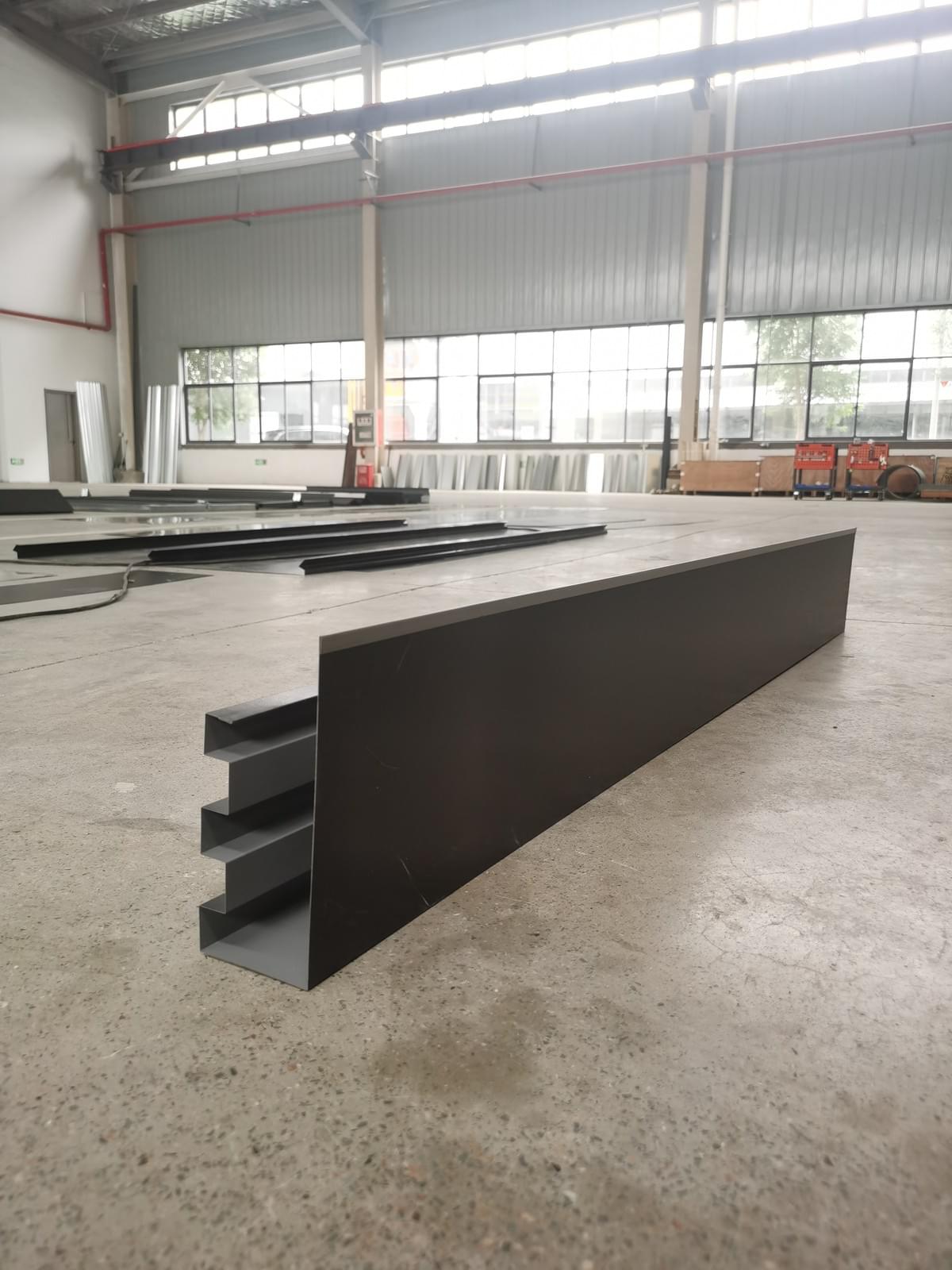 Curved roof drains into a continuous gutter