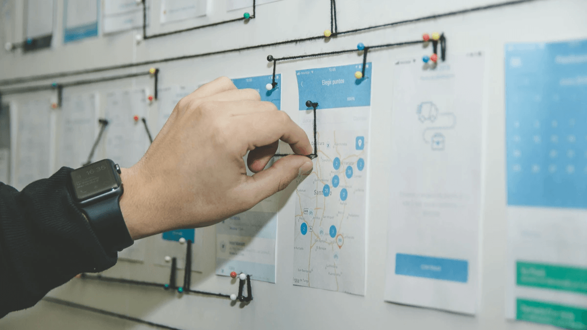 A team member arranging screens to map a connected customer journey