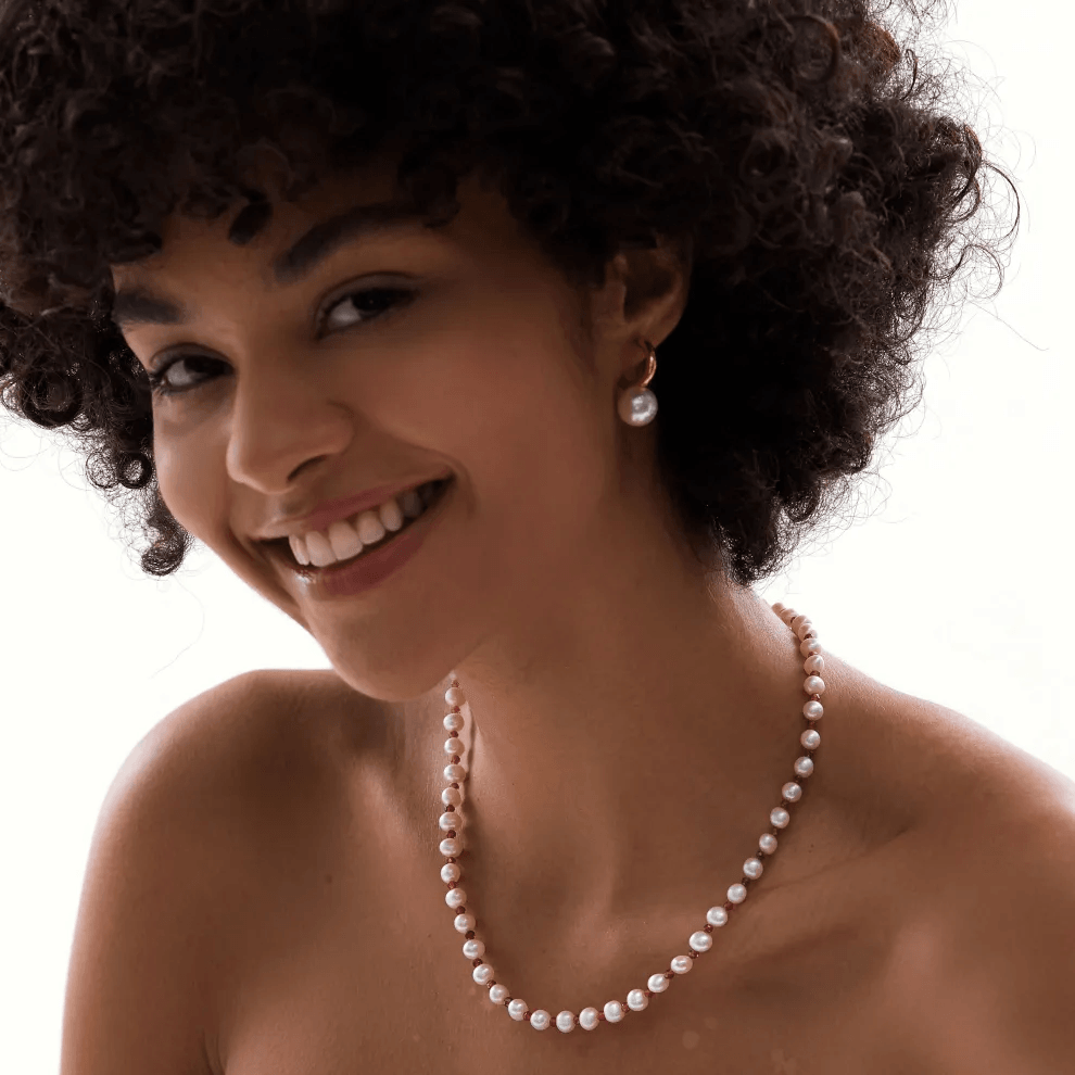 woman wearing white pearl necklace choker elegantly styled