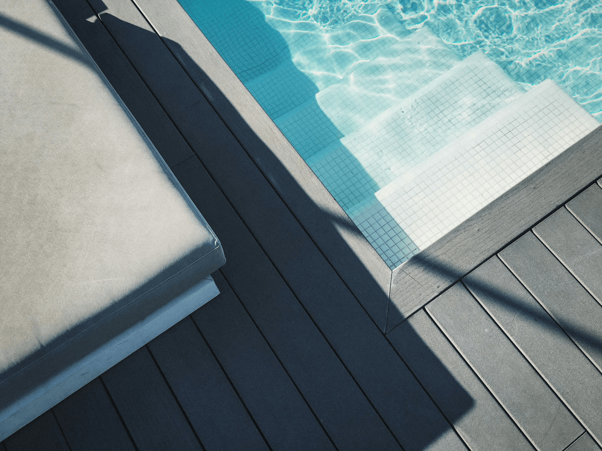 composite decking around inground pool provides safety and comfort.