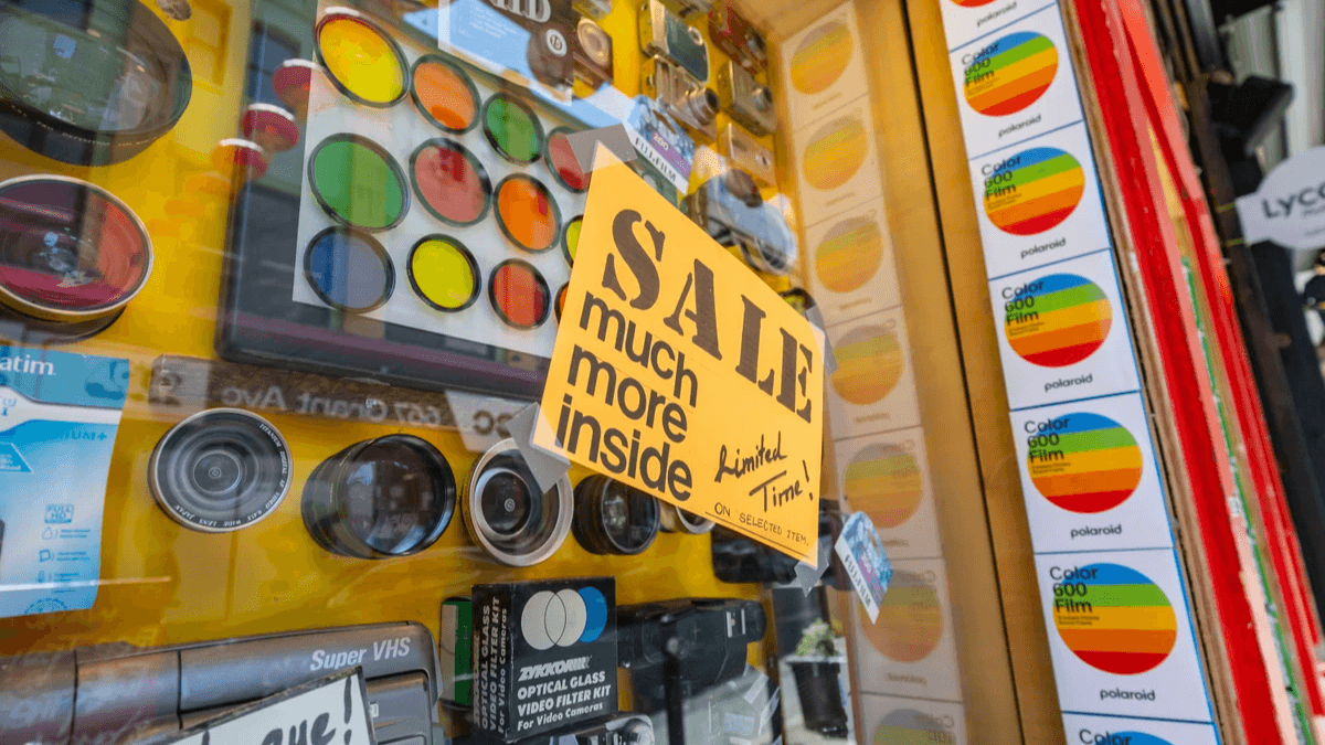  Yellow sale sign in a colorful shop window representing a clearly visible promotion