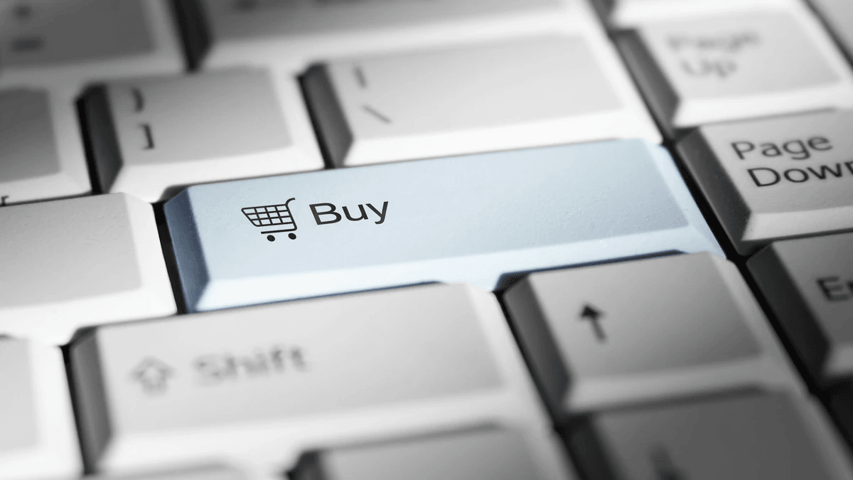 Shopper using ecommerce product search while comparing products on a laptop