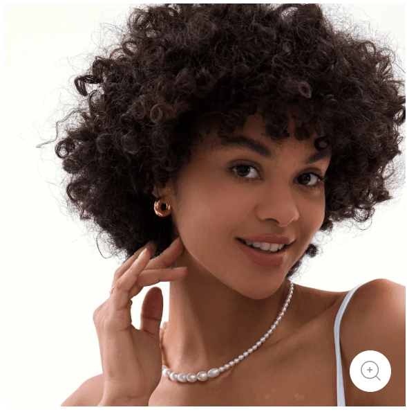 Elegant woman wearing stunning drop hoop earrings gold