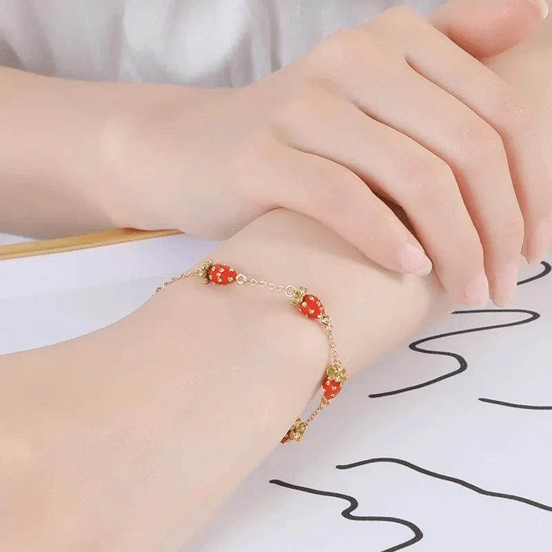 Stylish layering of vibrant fruit bracelet showcasing charm designs.