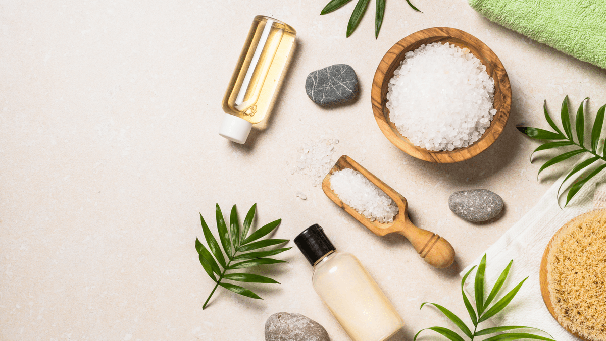 Spa Product Composition with Palm Leaves, Towel and Cosmetic Stone on a Flat Lay Display