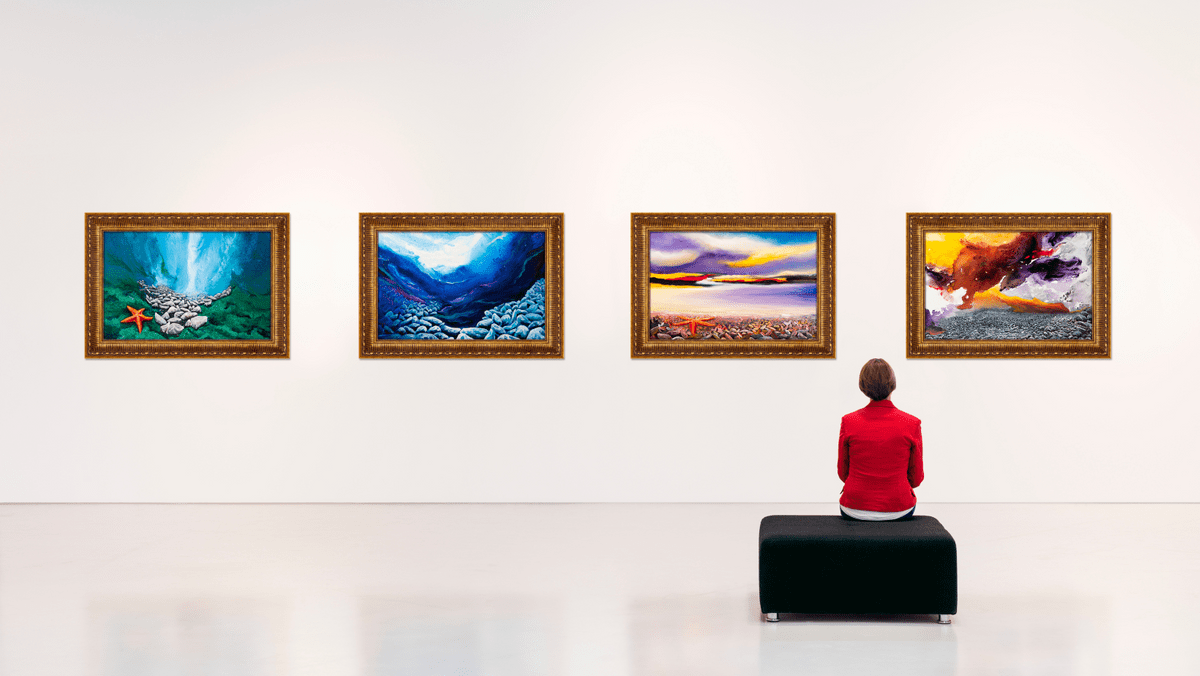 Woman in Red Blouse Sitting in an Art Gallery Looking at Four Paintings