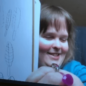 Artist Michelle Fromme smiling with a piece