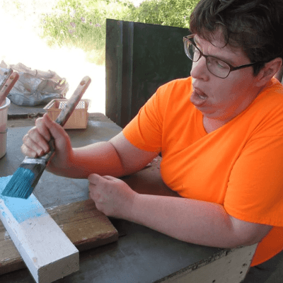 Artist Kathy Mayne displaying art.