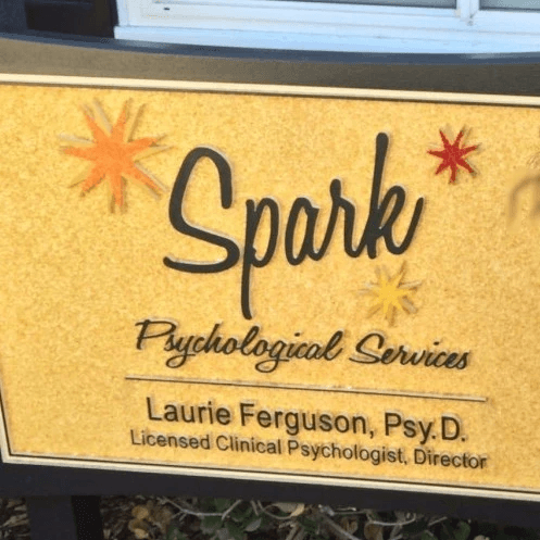 Office sign outside the building saying Spark Psychological Services