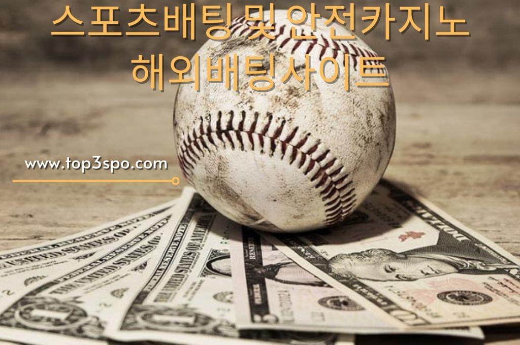 Dirty baseball and money in the wood table.