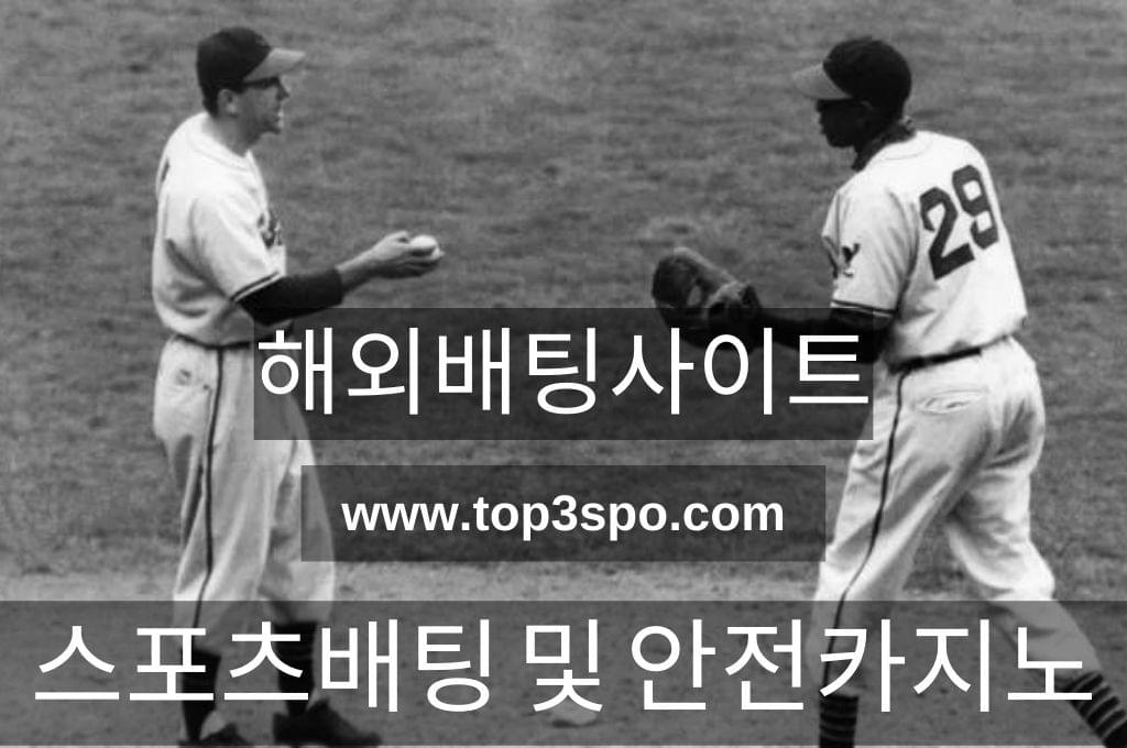 Black and white Two baseball players in game.