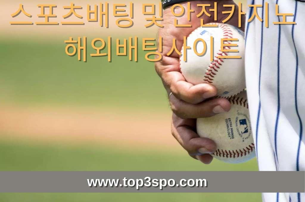 Two white Baseballs hold by the player.