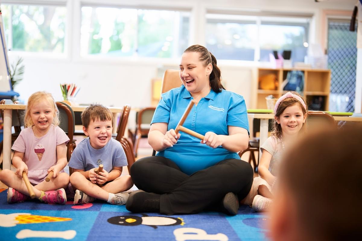 Educator leading a group session with preschool children