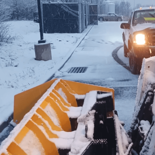 Actic sectional snow pusher being used in Dickson City PA. Skidsteer plow attachment