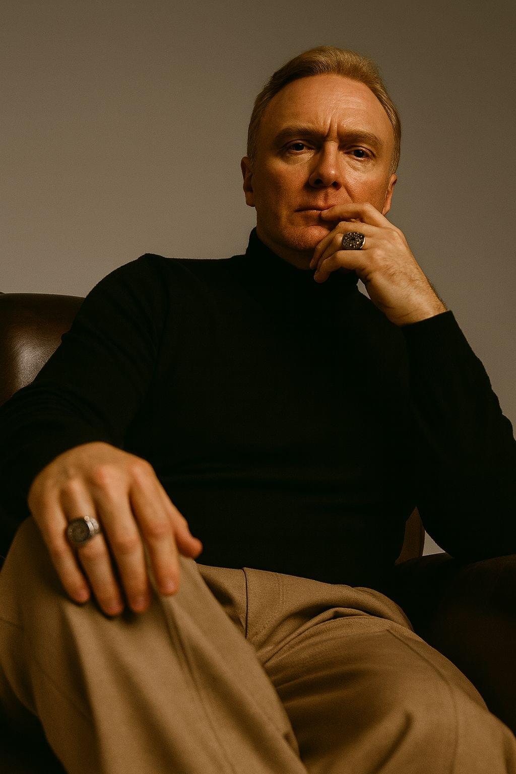 Editorial portrait of Patrick Osinski seated in a refined interior
