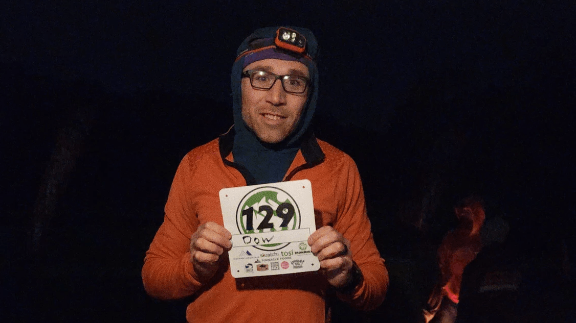Jason Dow, the third Olympus Mons Ultra finisher, holding his bib at night, Mohawk Mountain Cornwall CT