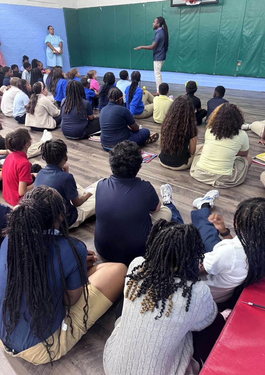 Maurice F. Martin engaging a large school student audience
