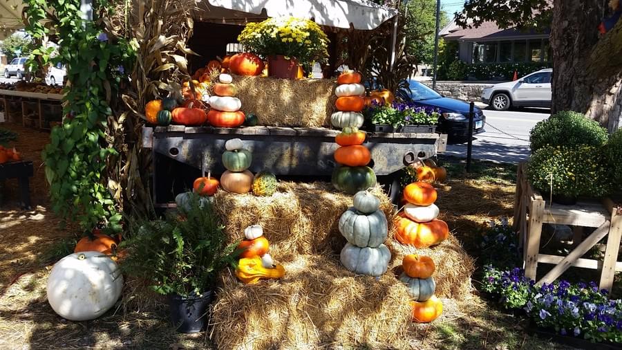 Pumpkins stacked on straw bales