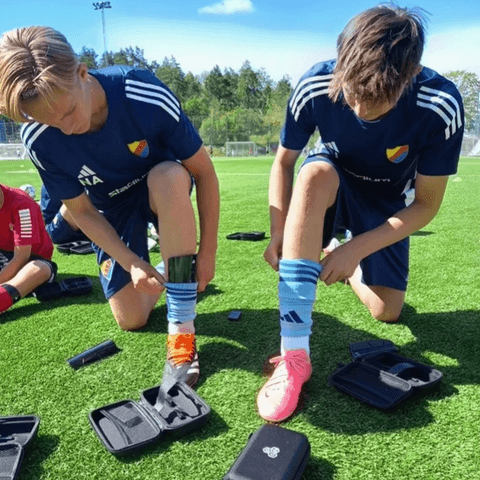 Players wearing smart shin guards before training starts.