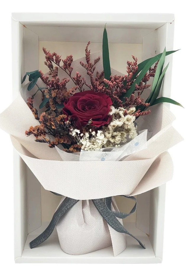 beautifully designed preserved rose gift box with accompanying treats