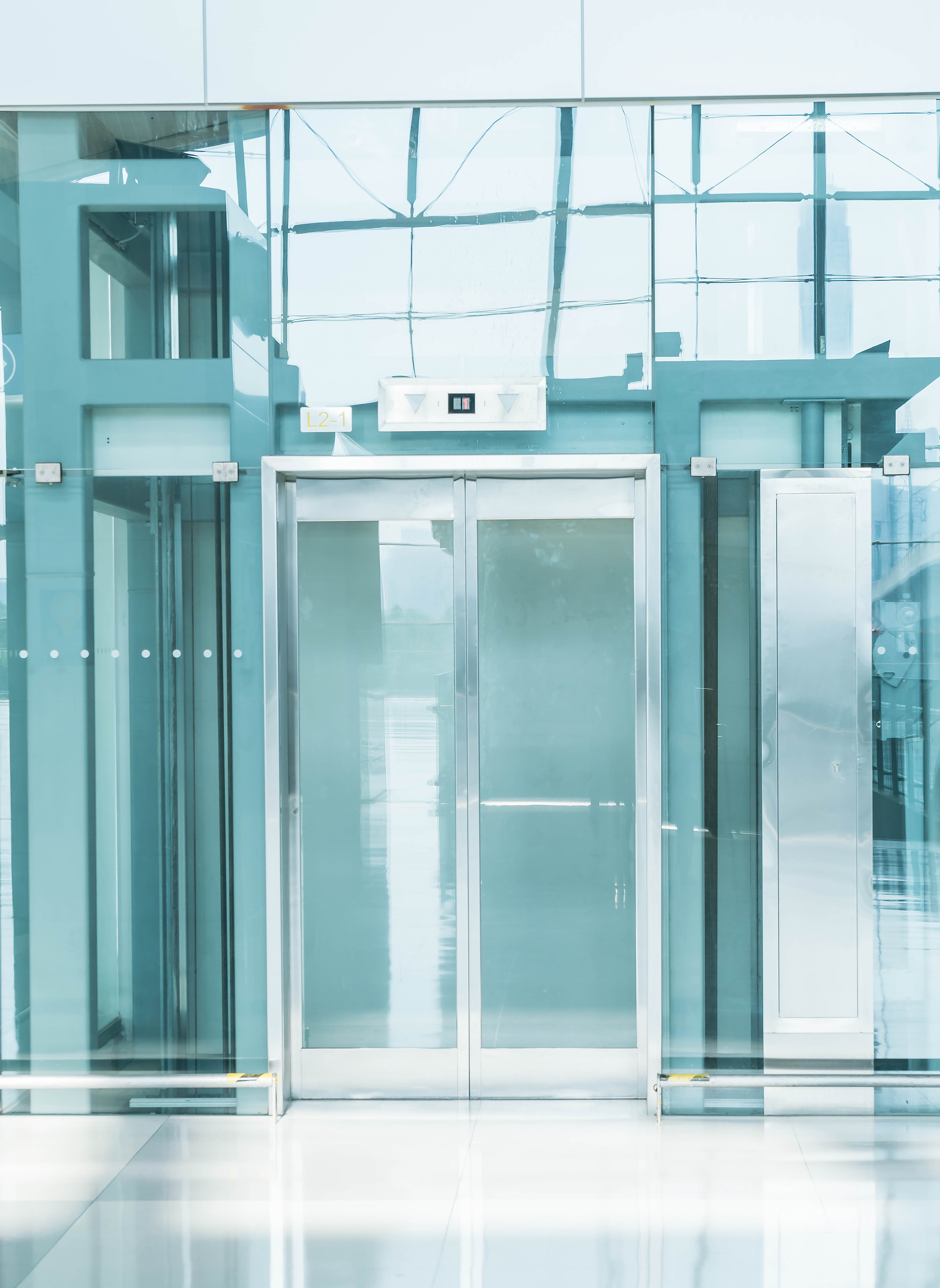 Professional technician inspecting elevator hoistway for optimal performance Professional technician inspecting elevator hoistway for optimal performance