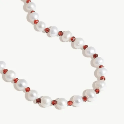 Stunning close-up of cherry necklace silver featuring vibrant red beads.